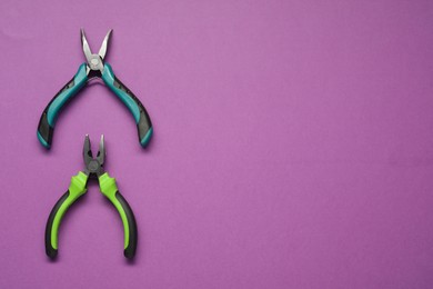 Pliers on purple background, flat lay. Space for text