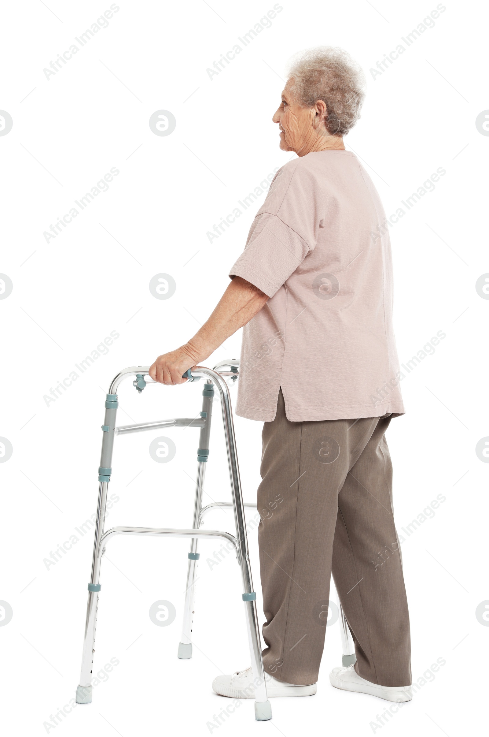 Photo of Full length portrait of elderly woman using walking frame isolated on white