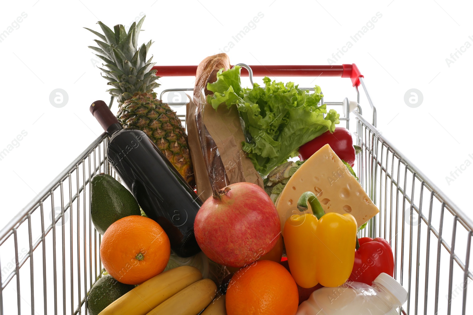 Photo of Shopping cart with groceries on white background, closeup