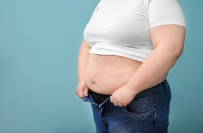 Photo of Overweight woman on color background