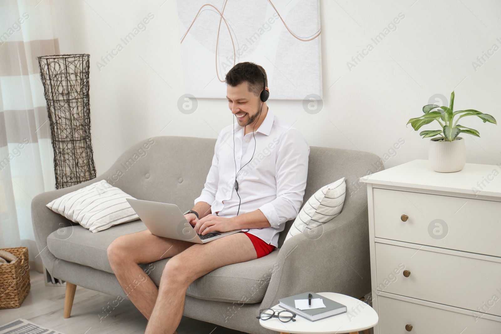 Photo of Businessman in underwear pretending to wear formal clothes during video call at home