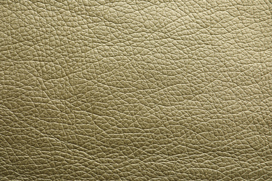 Photo of Texture of olive leather as background, closeup
