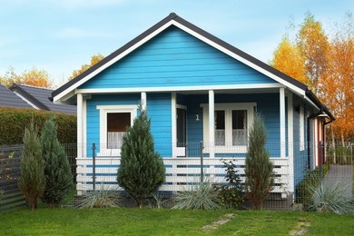 Beautiful light blue house outdoors. Real estate