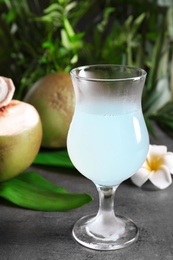 Glass of fresh coconut water on table