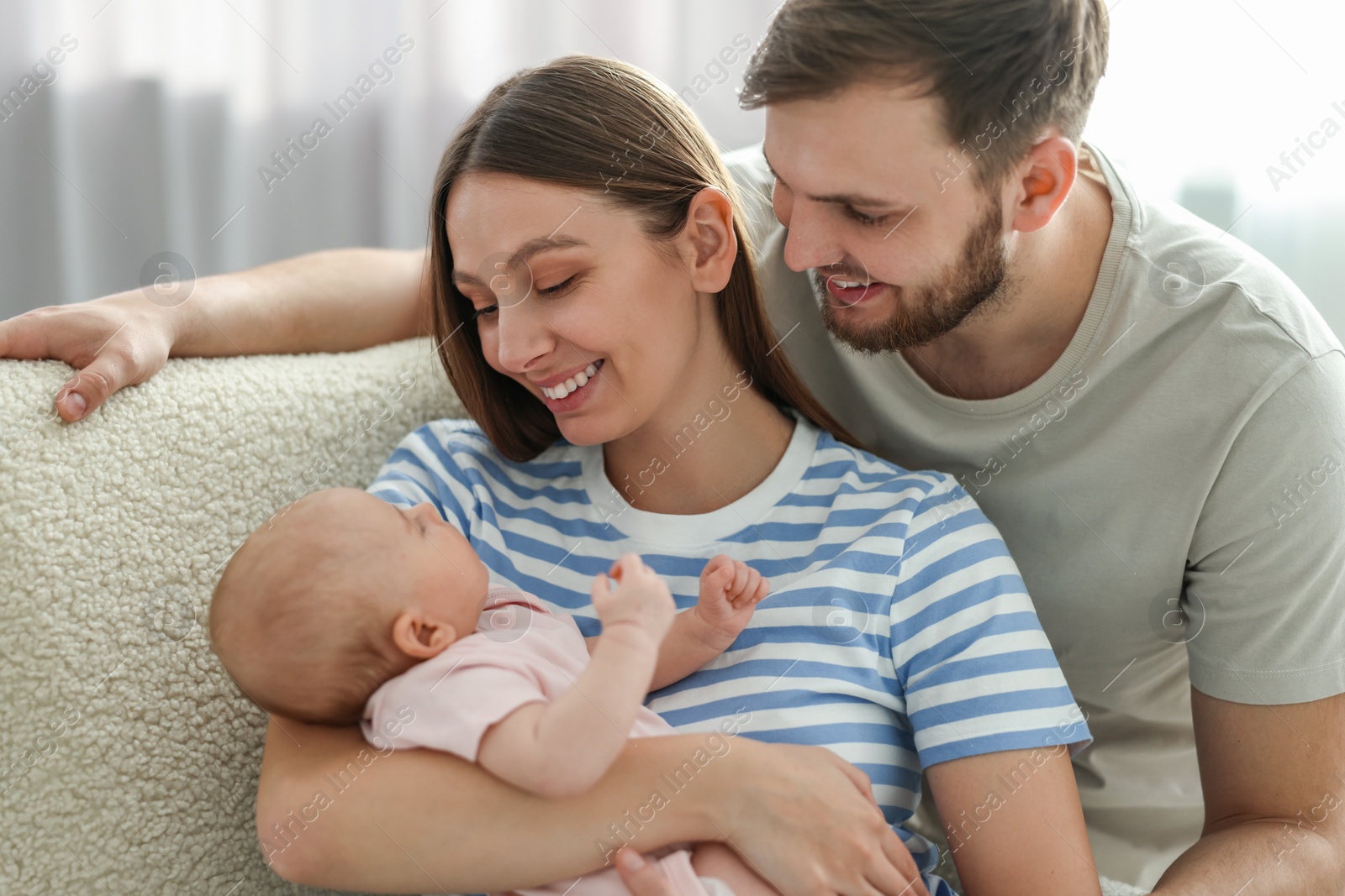 Photo of Happy family. Parents with their cute baby at home