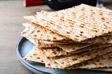 Photo of Stack of traditional matzos on wooden table, closeup