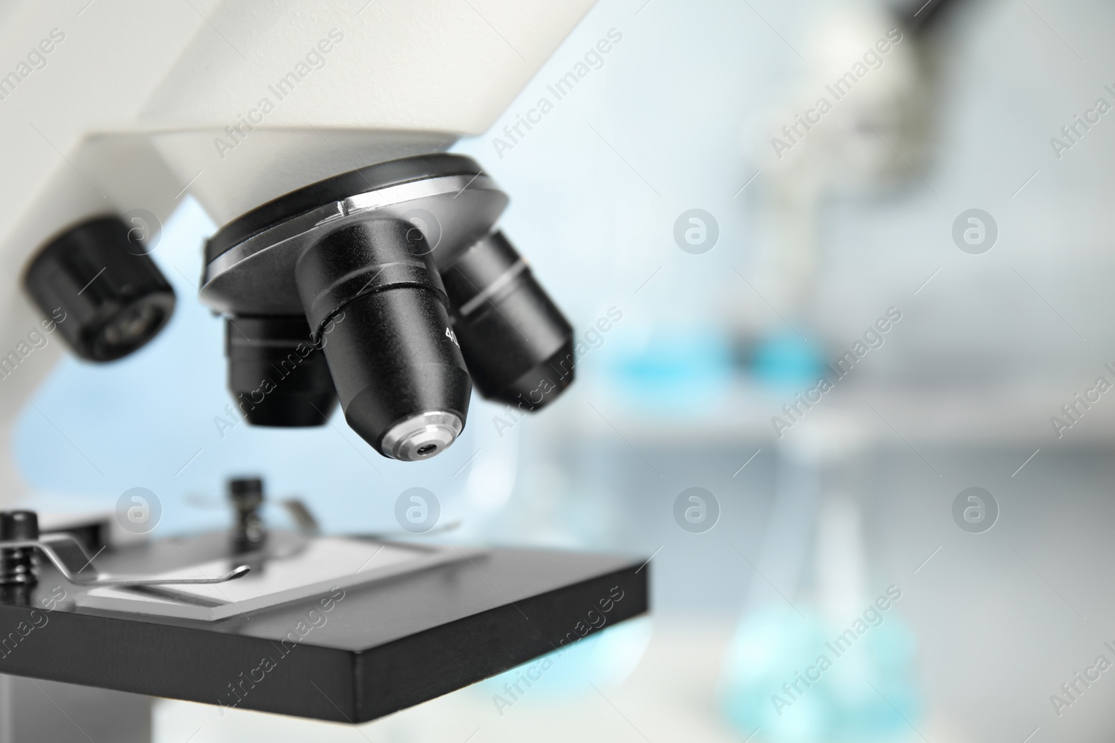 Photo of Closeup view of modern microscope in laboratory, space for text. Medical equipment