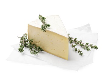 Photo of Piece of tasty camembert cheese and thyme isolated on white