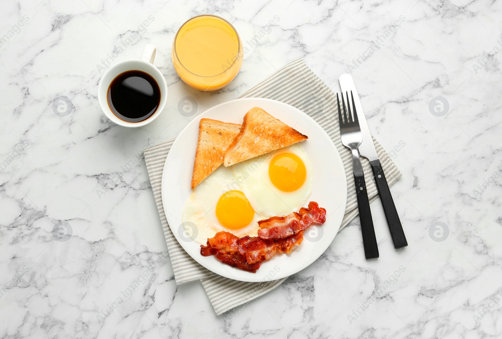 Photo of Delicious breakfast with sunny side up eggs served on white marble table, flat lay