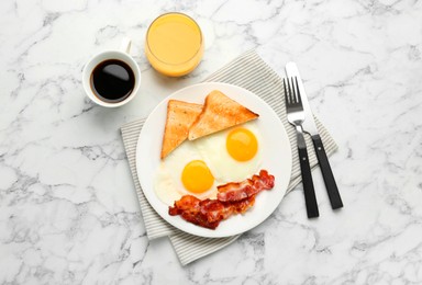 Delicious breakfast with sunny side up eggs served on white marble table, flat lay