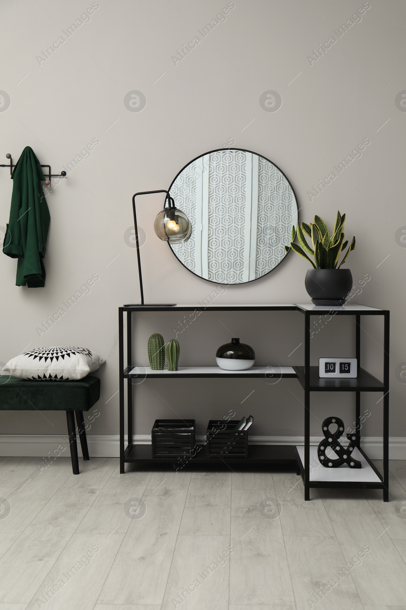 Photo of Hallway with stylish console table and mirror. Interior design