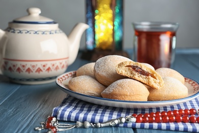 Photo of Traditional Islamic cookies and tea on table, space for text. Eid Mubarak