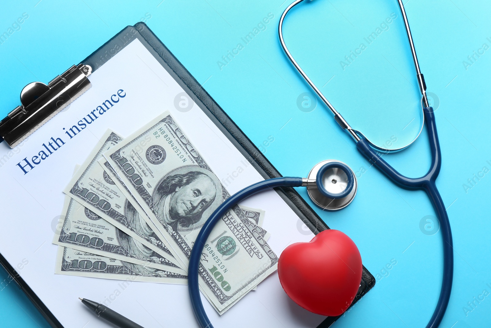 Photo of Flat lay composition with medical insurance form, money, heart and stethoscope on blue background
