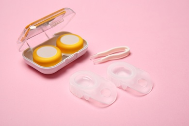 Photo of Contact lenses and accessories on color background