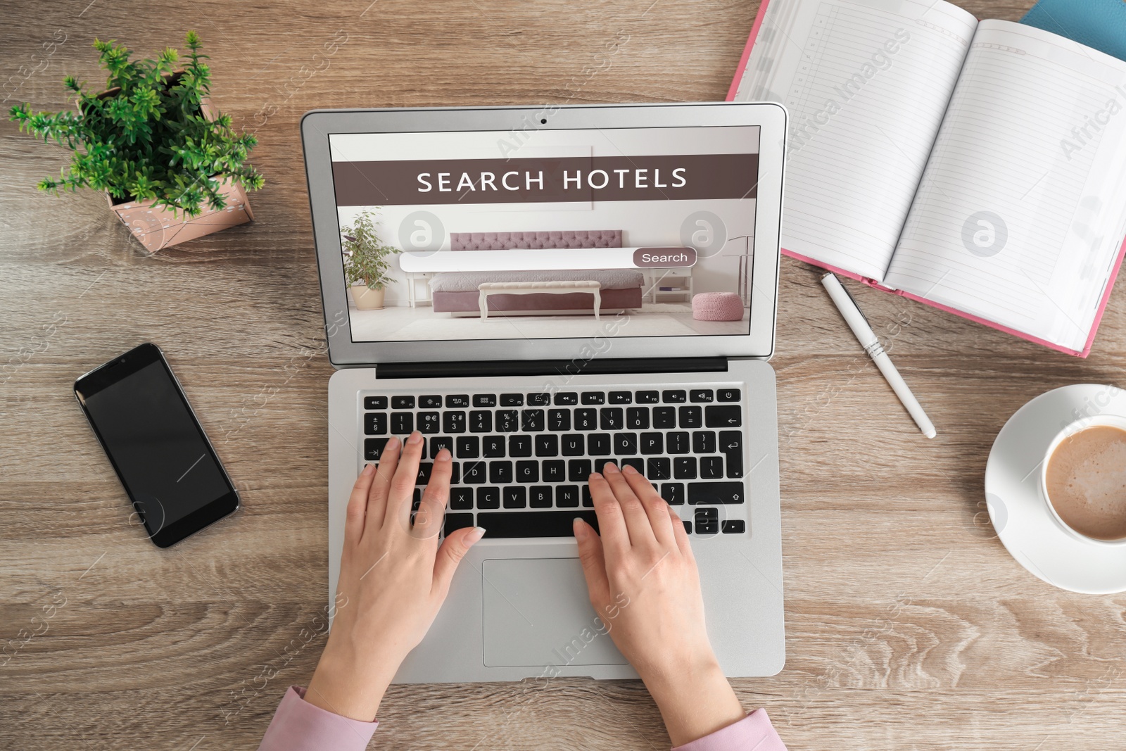 Image of Woman searching hotel using laptop at table, top view. Booking online service