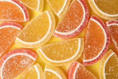 Photo of Tasty jelly candies on color background, top view