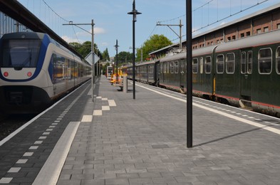 Photo of Modern trains at railway station on sunny day