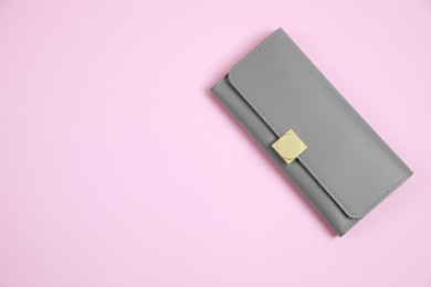 Photo of Stylish grey leather purse on pink background, top view. Space for text