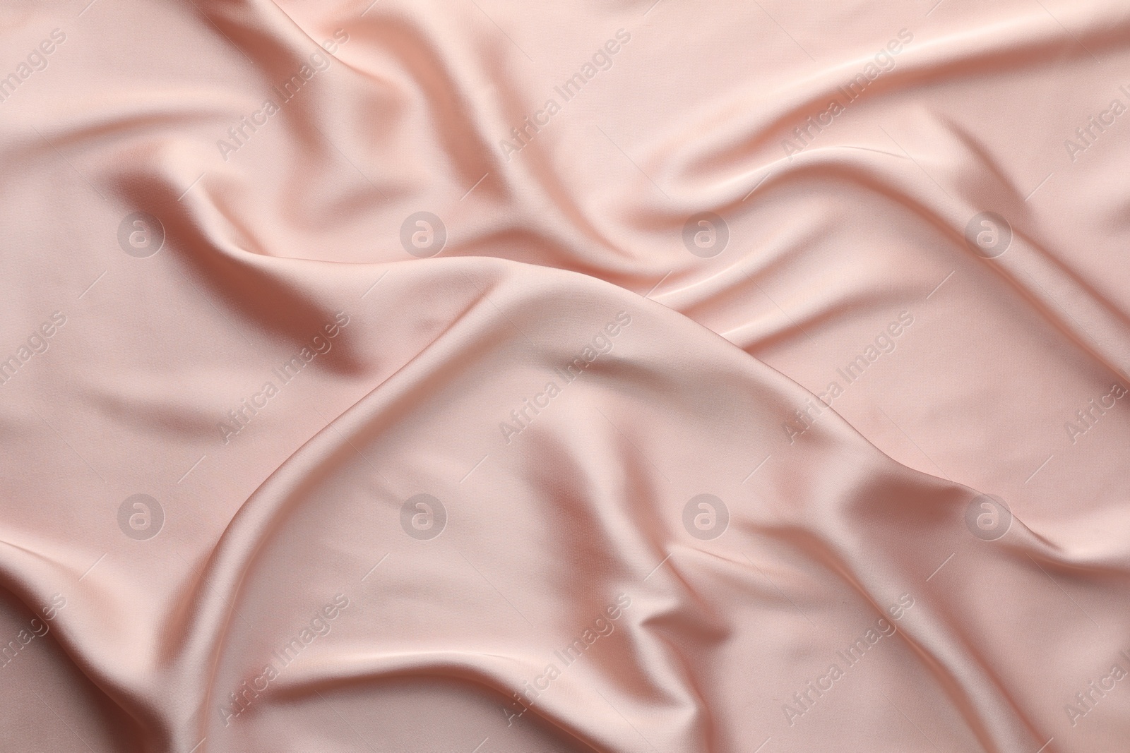 Photo of Crumpled pink silk fabric as background, top view