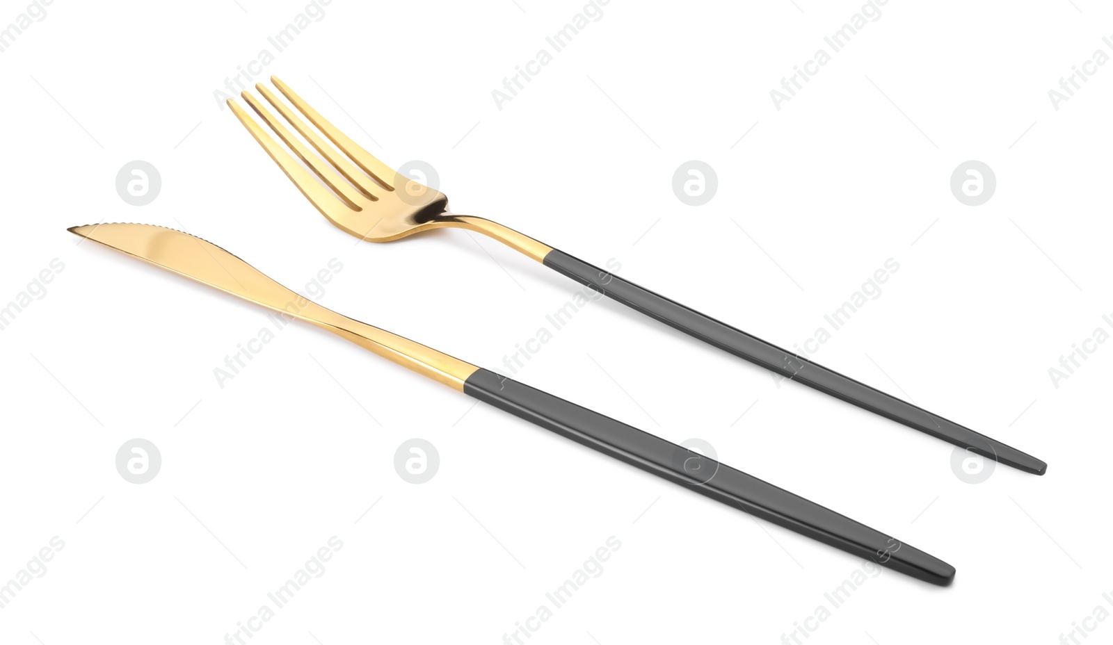 Photo of Shiny golden fork and knife isolated on white. Luxury cutlery