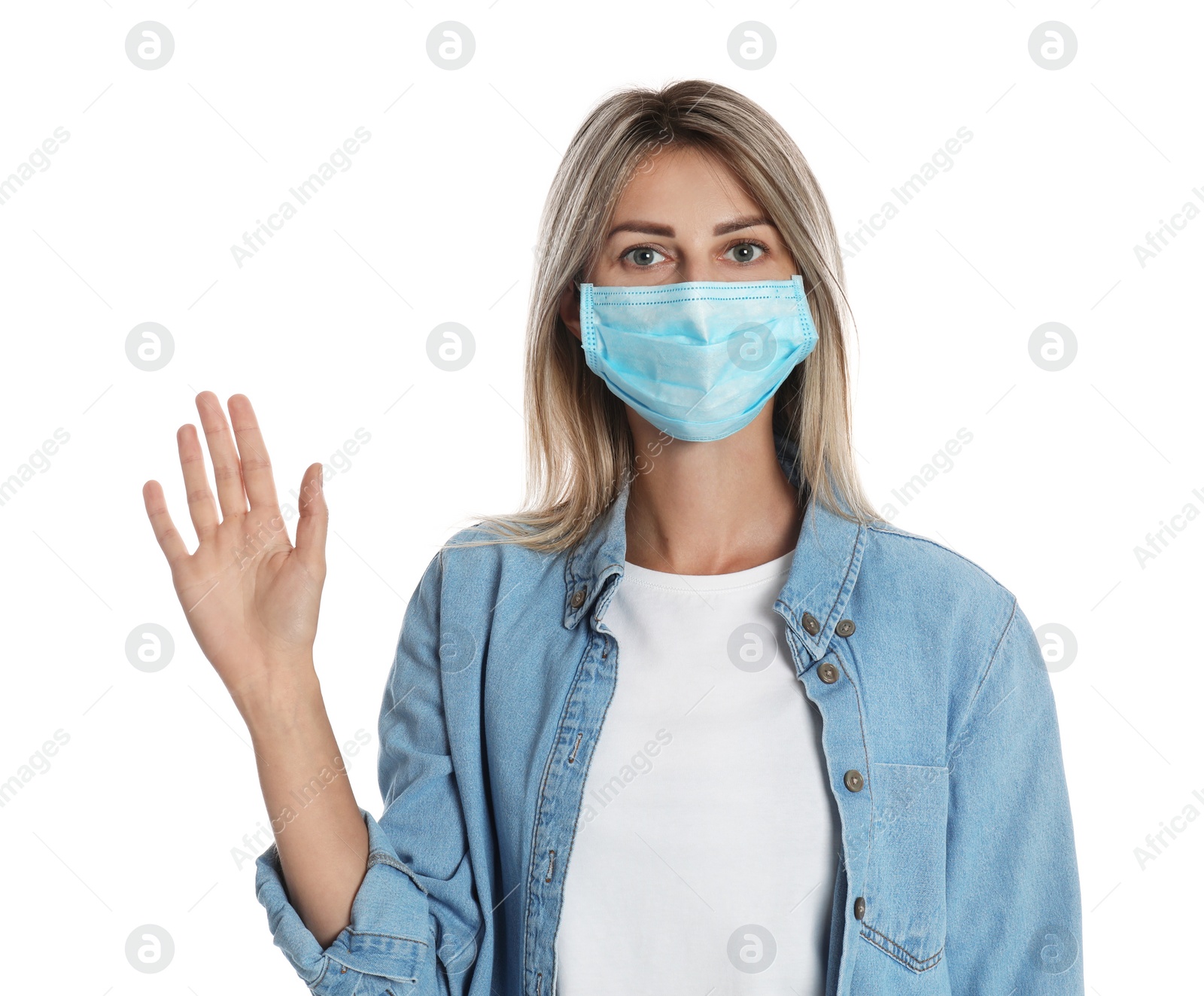 Photo of Woman in protective mask showing hello gesture on white background. Keeping social distance during coronavirus pandemic