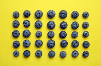 Flat lay composition with tasty blueberry on color background