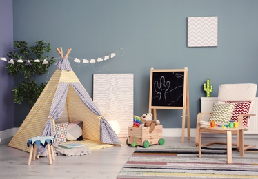 Photo of Modern room interior with play tent for child