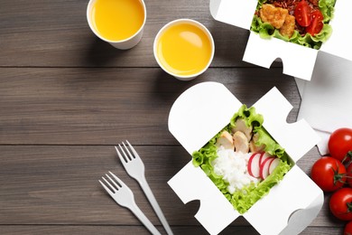 Photo of Flat lay composition with healthy takeaway food on wooden table