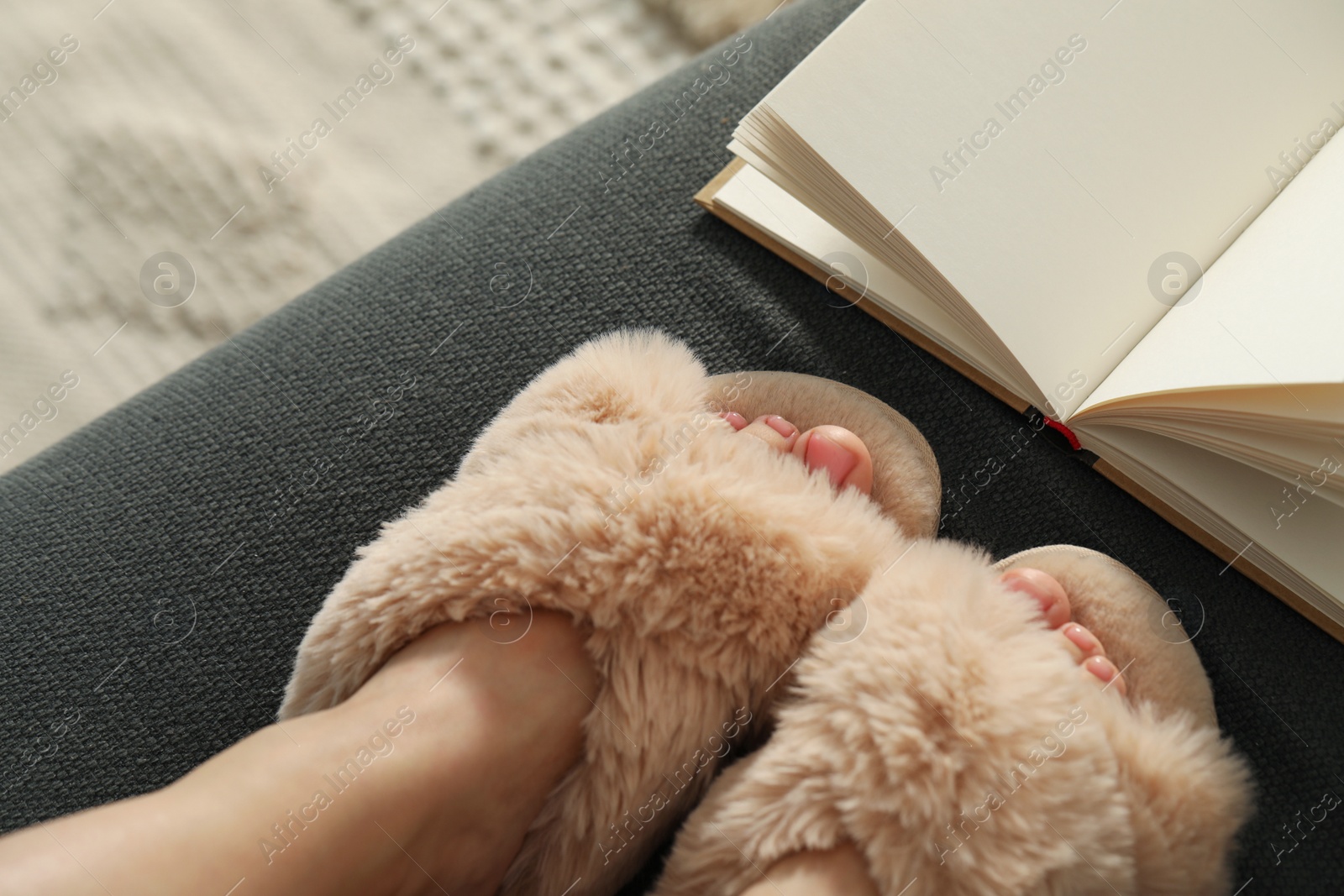 Photo of Woman wearing soft comfortable slippers at home, closeup