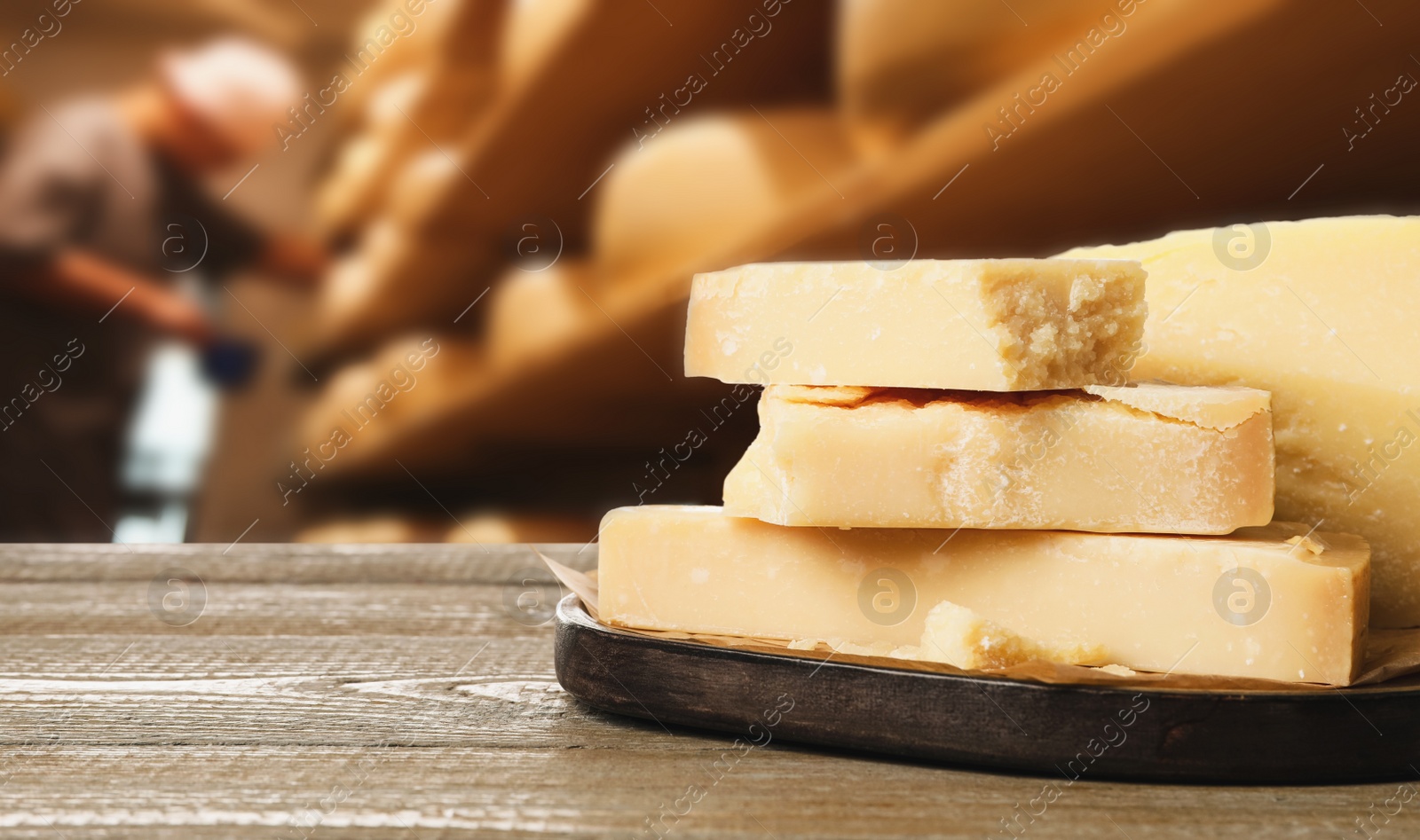 Image of Delicious parmesan cheese on wooden table in warehouse, space for text