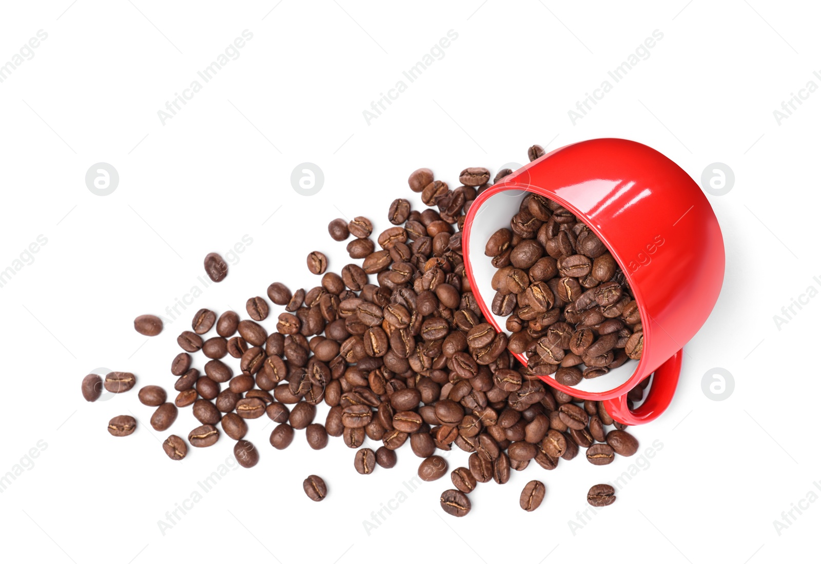 Photo of Overturned cup with roasted coffee beans on white background, top view