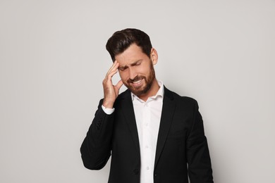 Photo of Stressed bearded man on light grey background