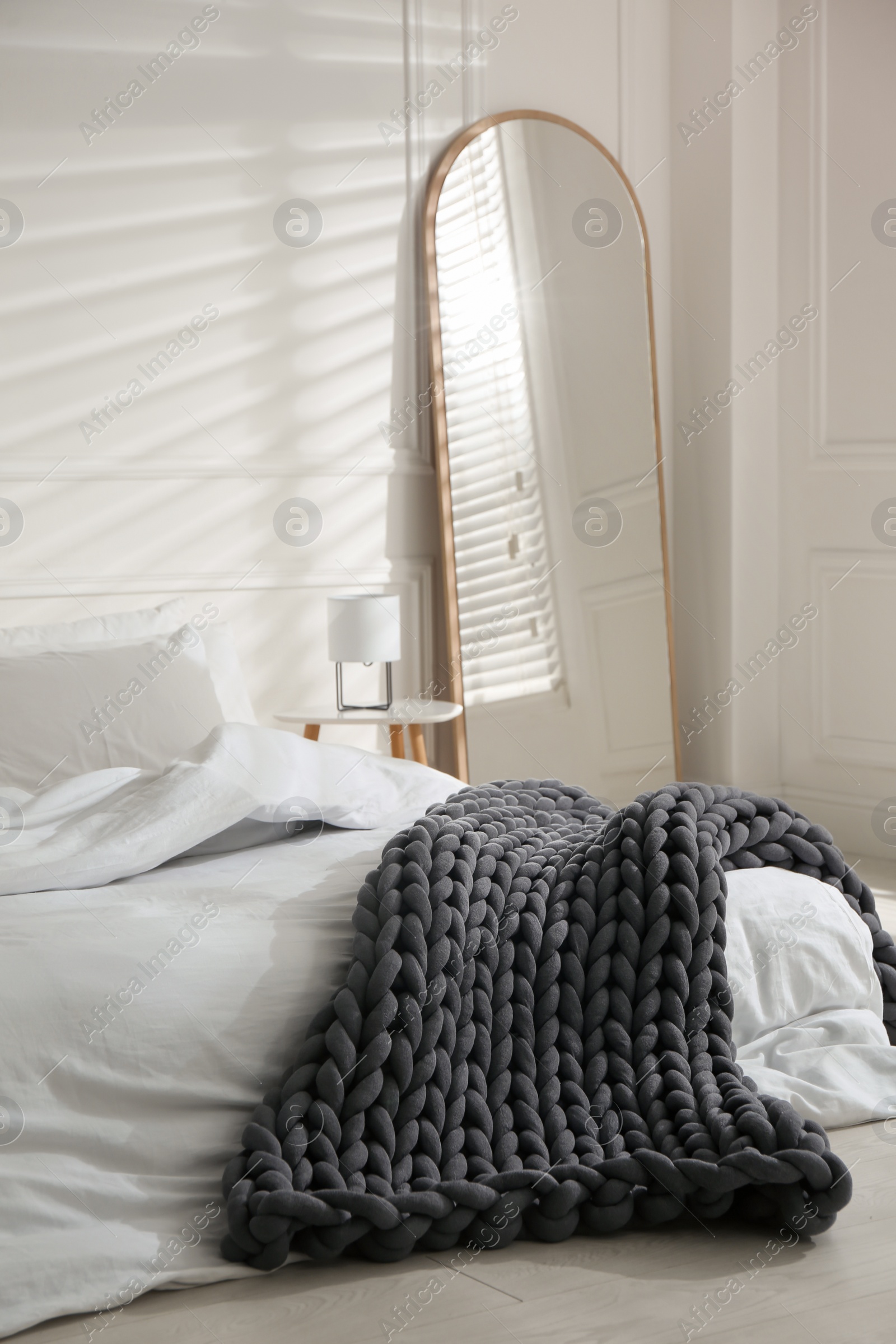 Photo of Soft chunky knit blanket on bed in room