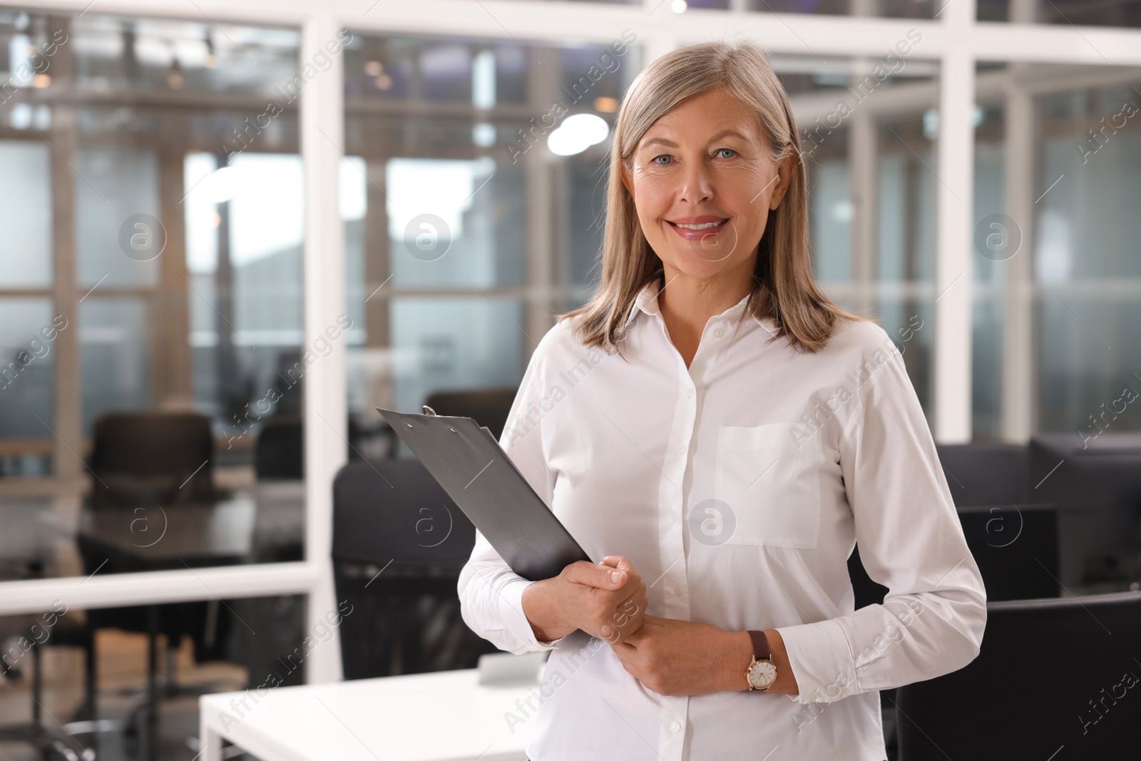 Photo of Smiling woman with clipboard in office, space for text. Lawyer, businesswoman, accountant or manager