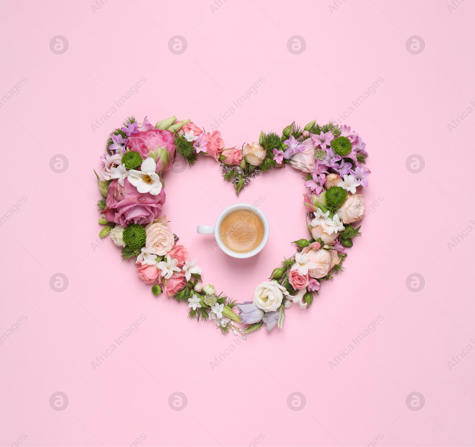 Photo of Beautiful heart made of different flowers and coffee on pink background, flat lay