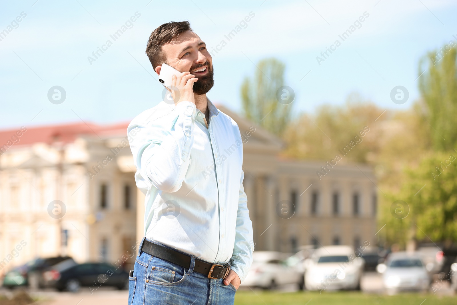 Photo of Portrait of young man talking on phone outdoors