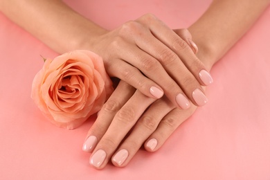 Closeup view of woman with rose on color background. Spa treatment