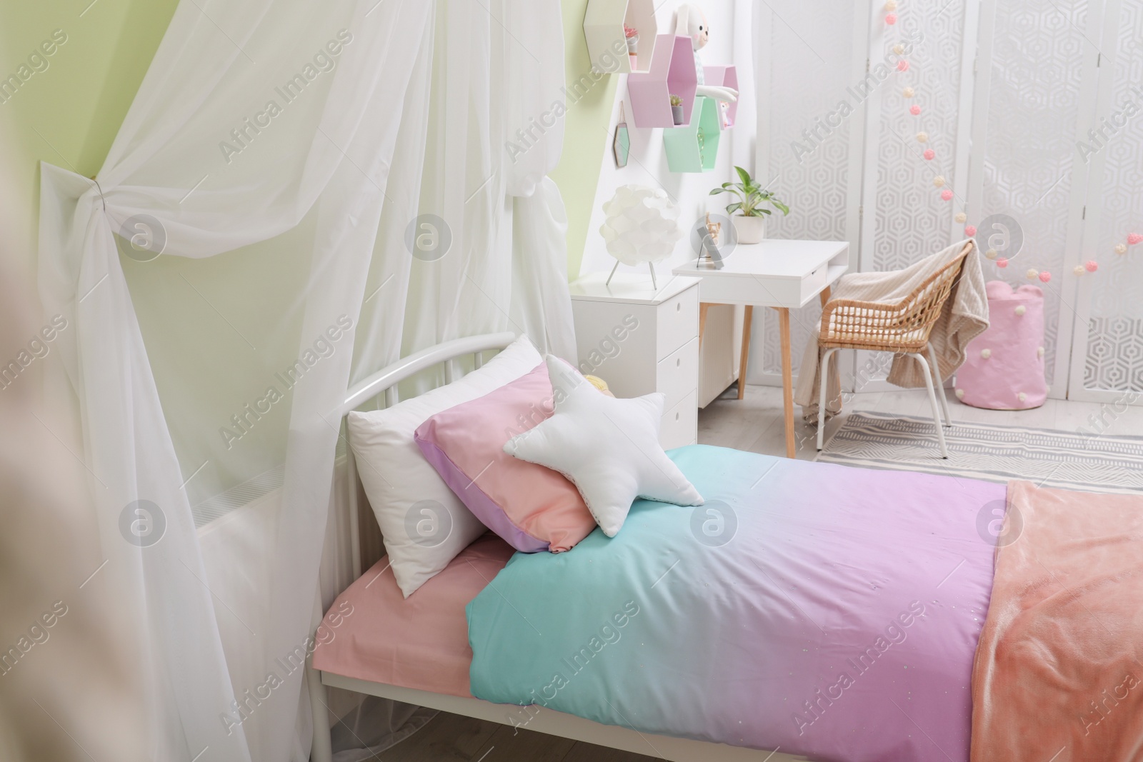 Photo of Cute child's room interior with bed and comfortable workplace