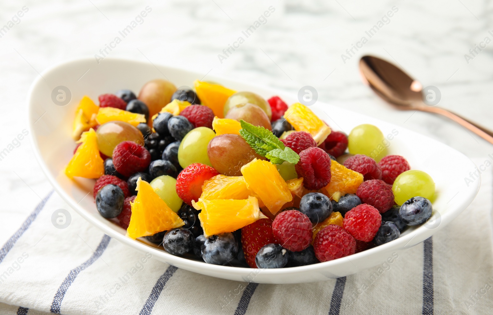 Photo of Fresh tasty fruit salad on table, closeup