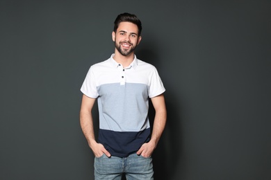 Photo of Portrait of handsome man smiling on grey background