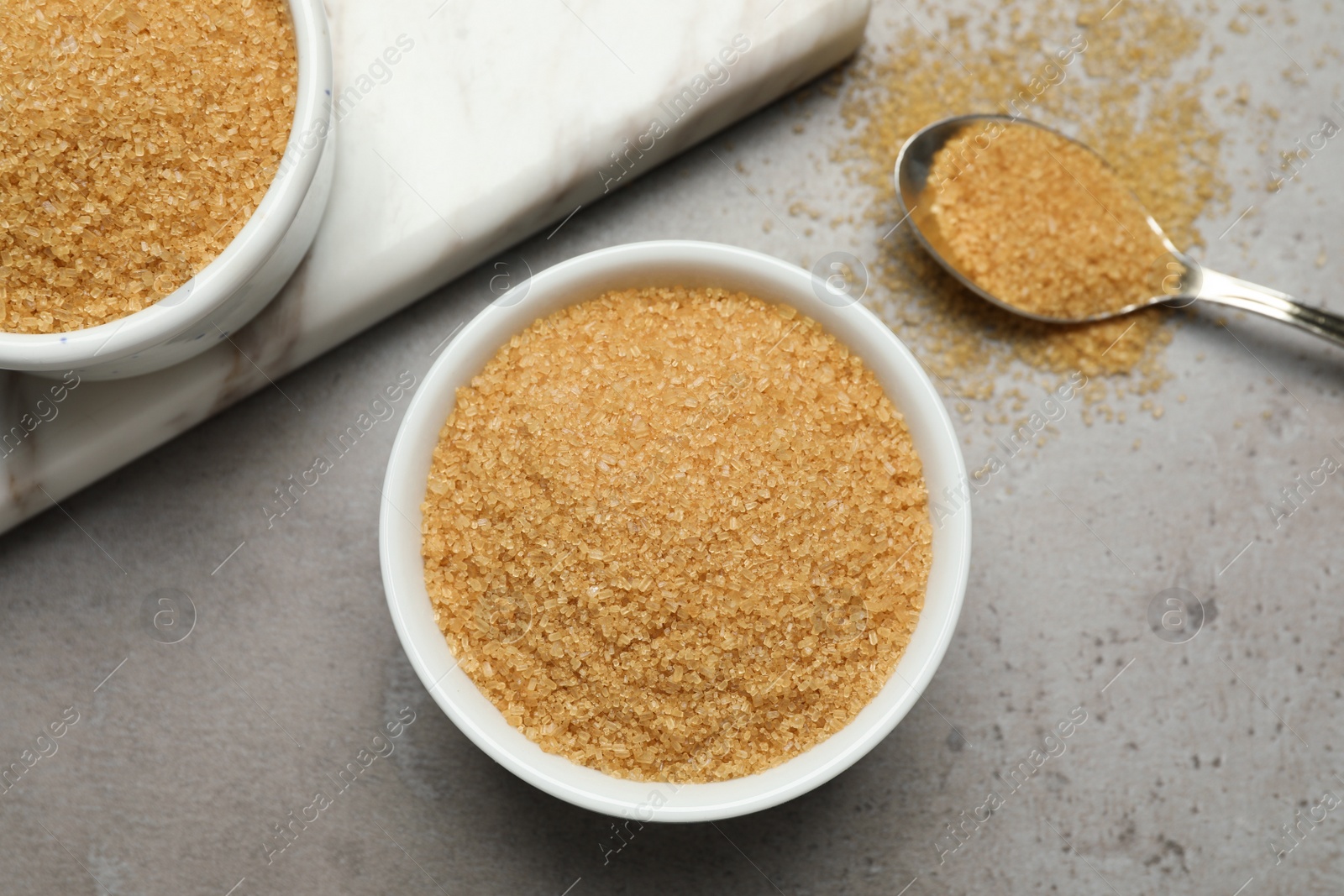 Photo of Brown sugar on grey table, flat lay