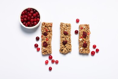 Photo of Tasty granola bars and berries on white background, flat lay