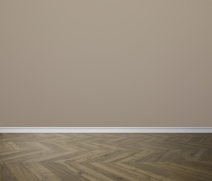 Image of Wooden floor and empty beige wall indoors