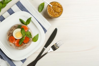 Delicious aspic with meat served on white wooden table, flat lay. Space for text