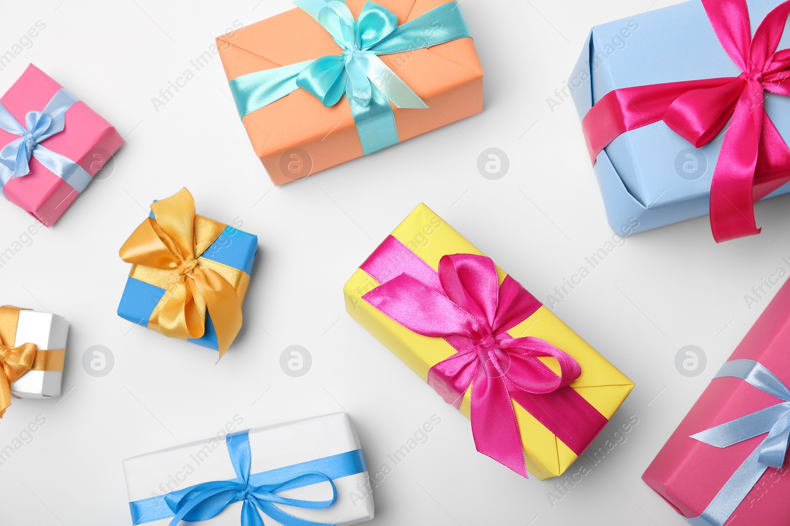 Photo of Flat lay composition with beautiful gift boxes on white background