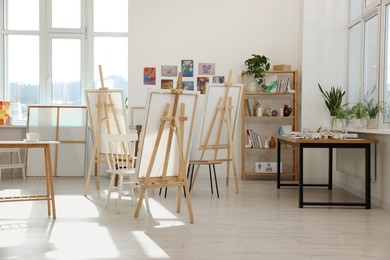 Photo of Stylish artist's studio interior with easels and canvases. Creative hobby
