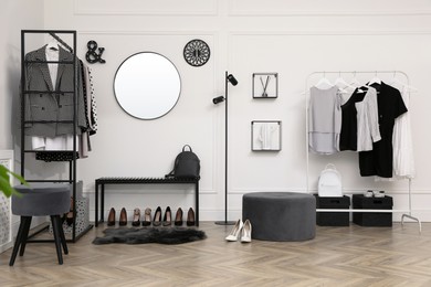 Photo of Dressing room with stylish clothes, shoes and accessories. Elegant interior design