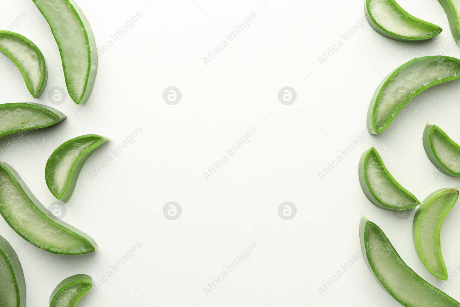 Photo of Fresh aloe vera slices on white background, flat lay. Space for text