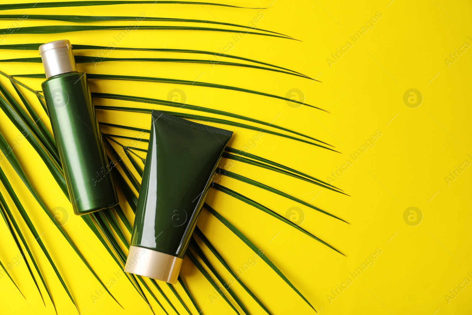 Photo of Cosmetic products on yellow background, flat lay. Space for text
