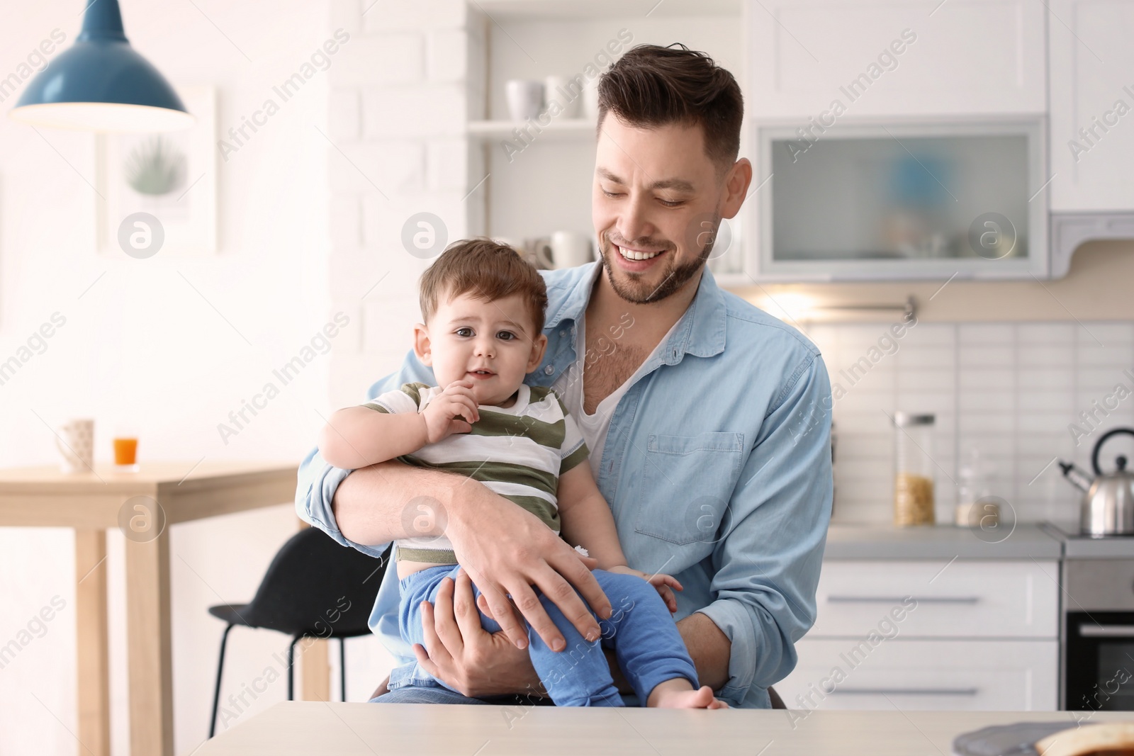 Photo of Dad and son at table in kitchen